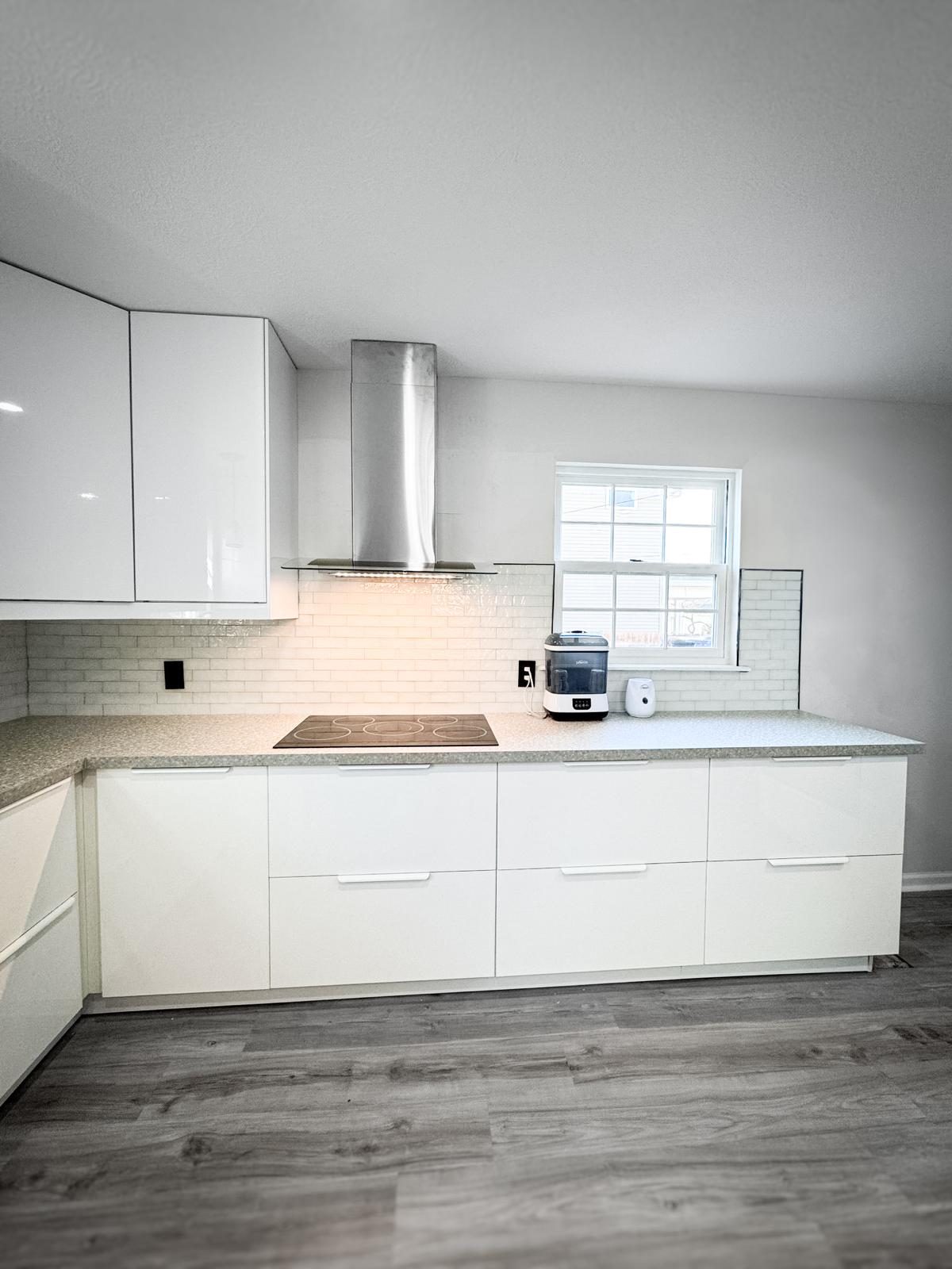 White cabinet and granite countertop kitchen remodel by Brito Solutions in Marysville, Ohio